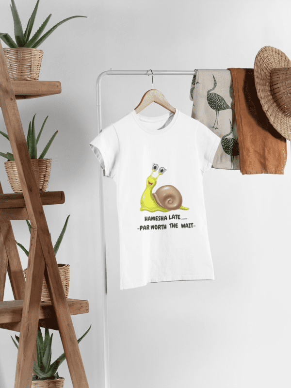 mockup-of-a-women-s-t-shirt-hanged-next-to-some-plant-pots-and-other-garments-27395 (2) Quirky "Hamesha Late worth the Wait" Graphic T Shirt